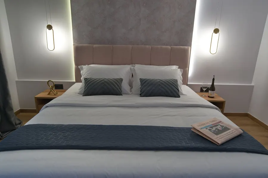 A king bed with a pink headboard
