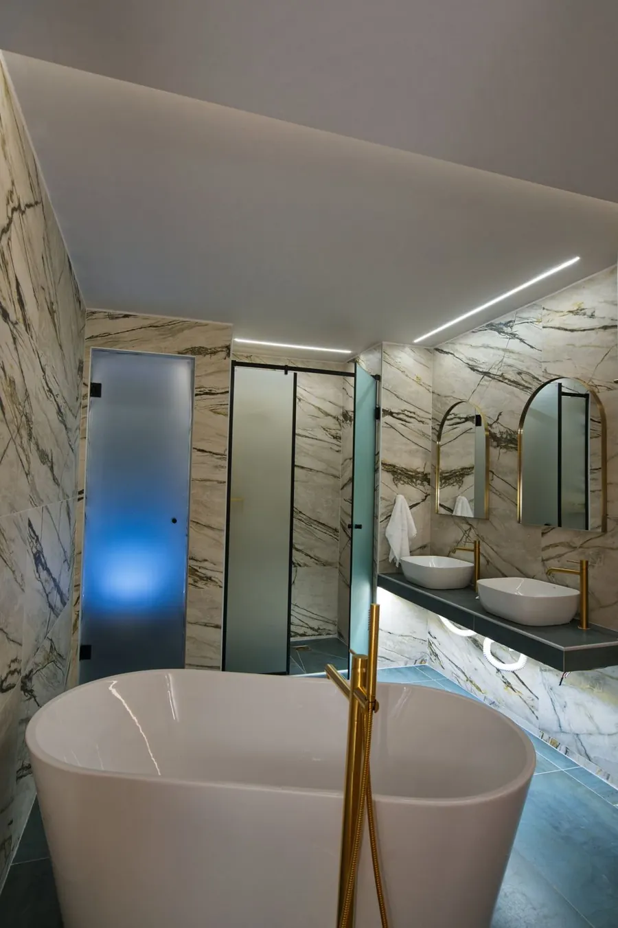 A freestanding bath in a marble bathroom